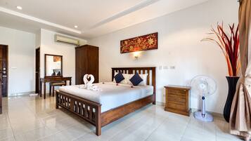 A bedroom with a wooden bed, a nightstand, a wall-mounted air conditioner, a standing fan, and a decorative wall piece.