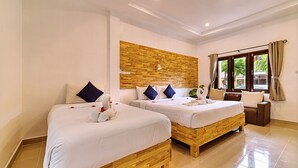 A hotel room with two wooden beds, white bedding, and a wooden accent wall. - The Bulin Residence (Koh Samui)