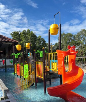 A water play area with slides and climbing structures, surrounded by a pool. - Sayong Resort (Kuala Kangsar)
