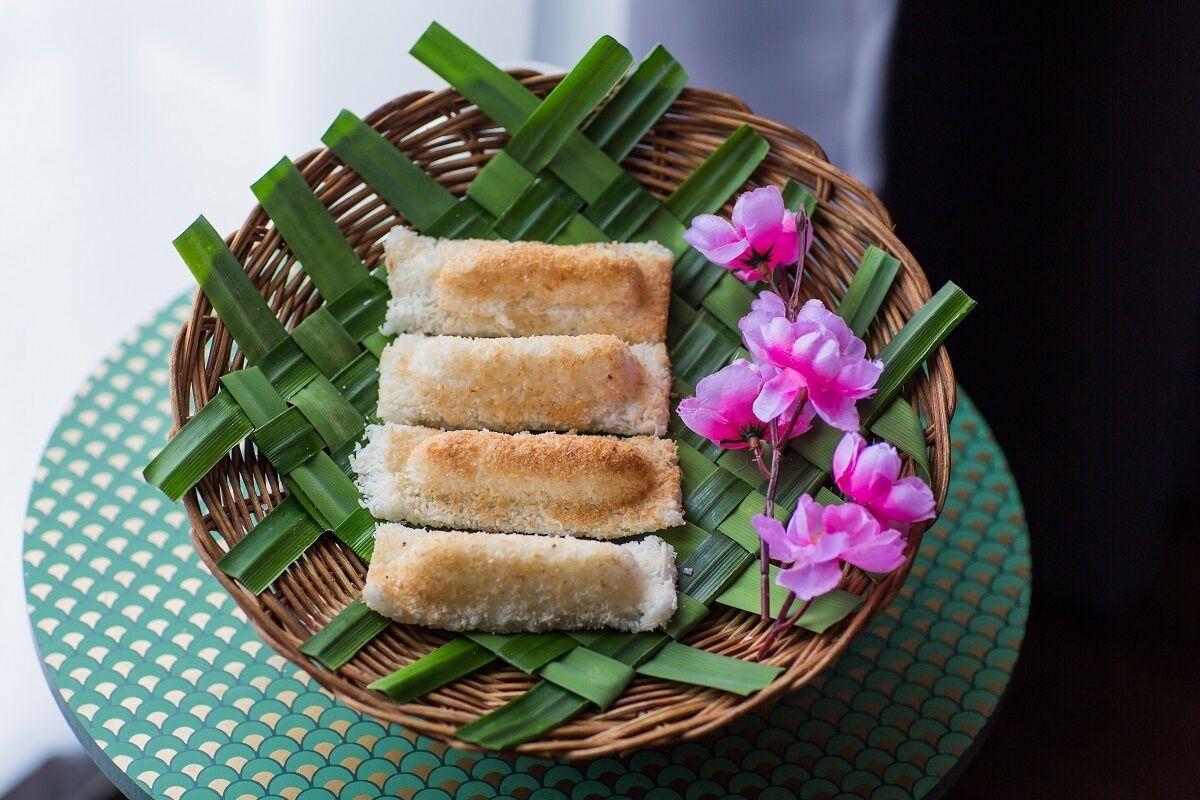 A basket with several pieces of food on a green mat.