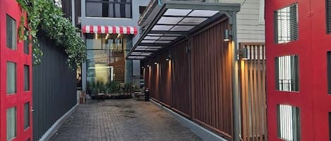 A Red Door entrance with a covered walkway leading to a building.