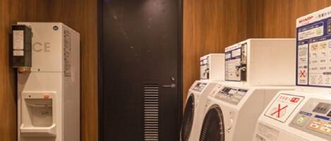 A laundry room with a water dispenser, a washing machine, and a dryer.