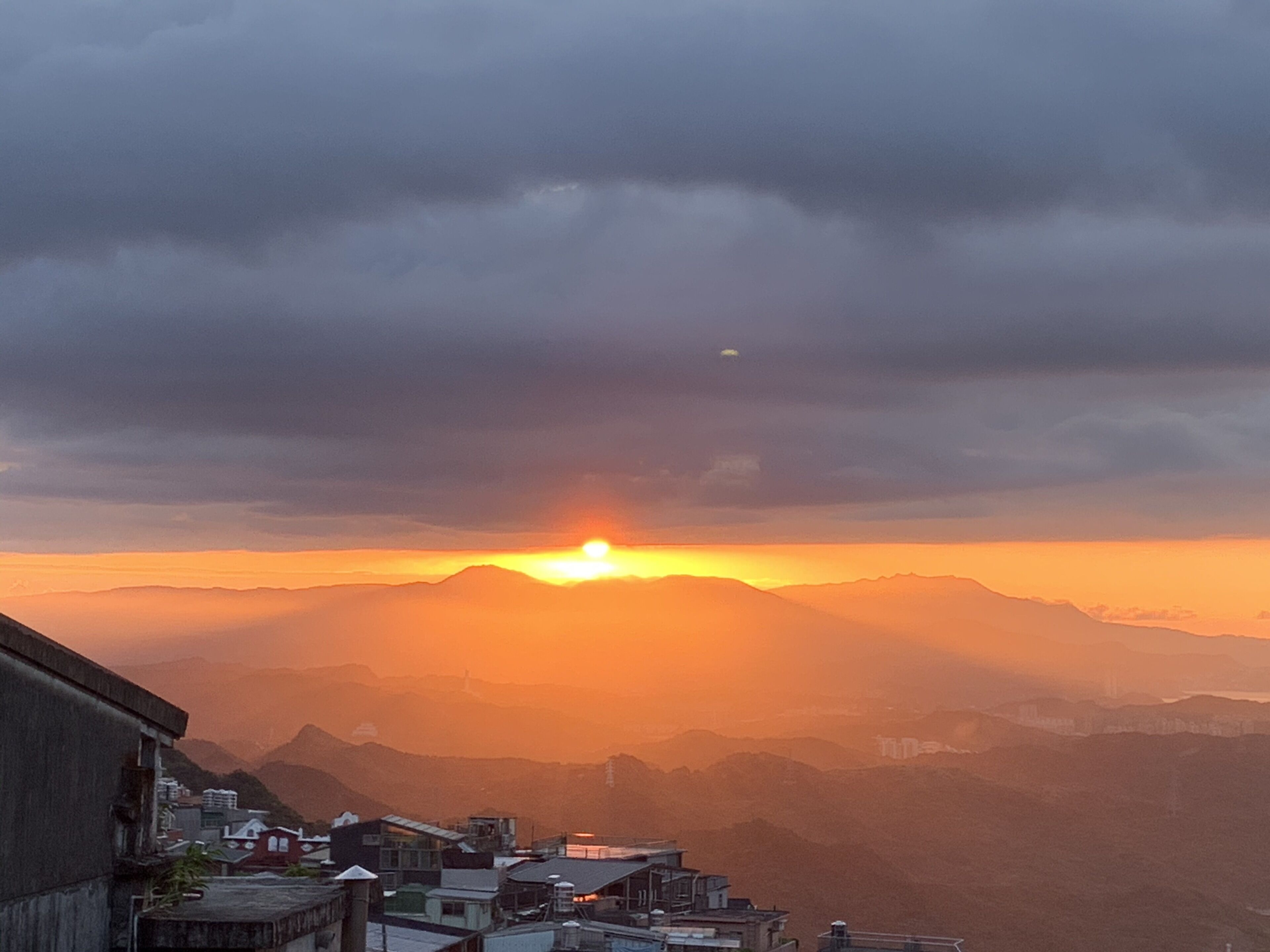 A mountainous landscape with a sunset.