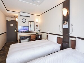 Relax in comfort with two single beds, a desk, and a kitchenette area.