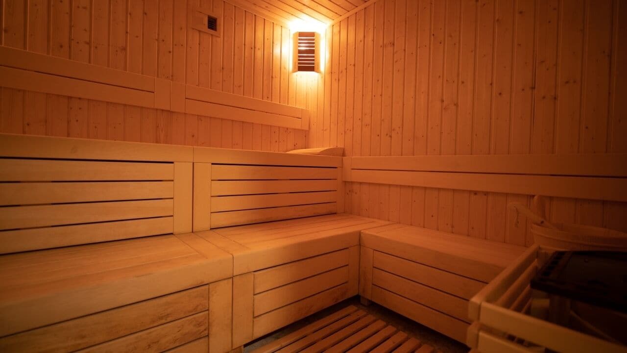 A wooden sauna with benches and a bench seat.