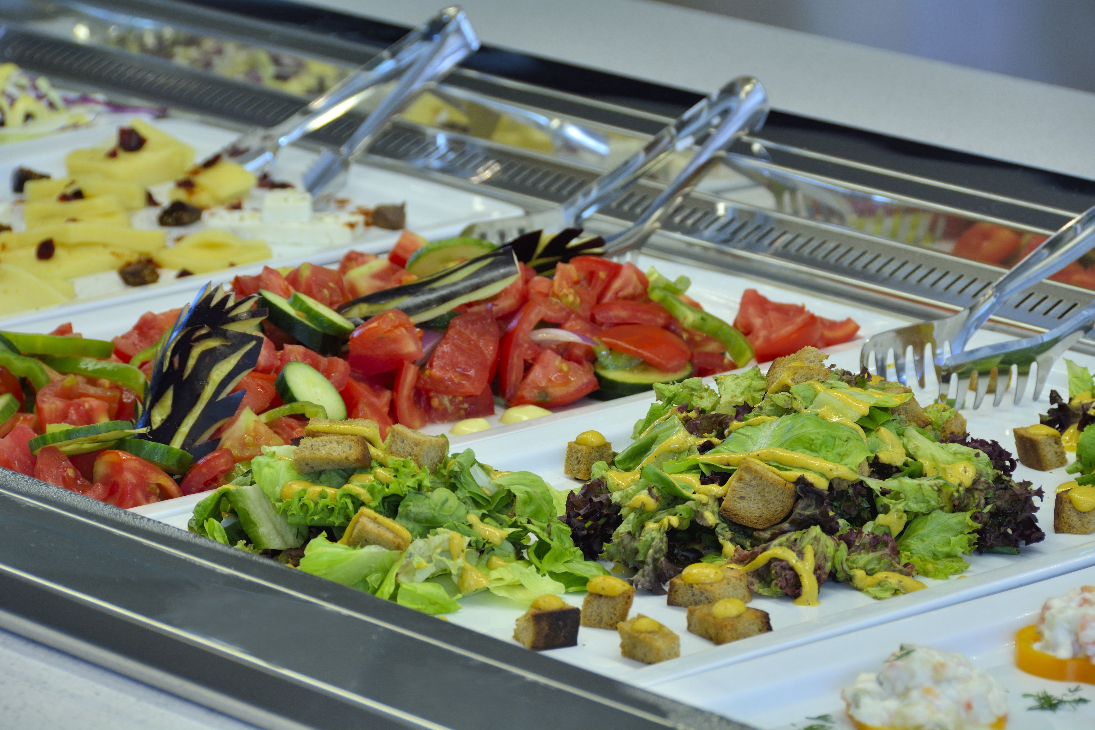 A buffet with various salads and appetizers.