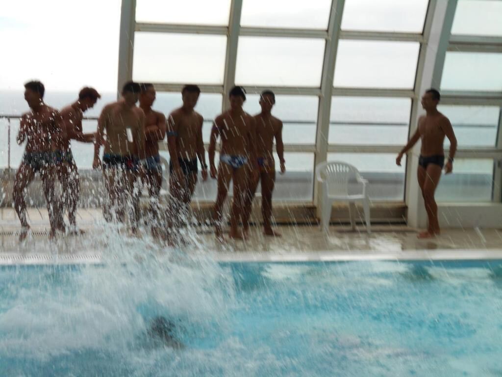 A swimming pool with people around it.