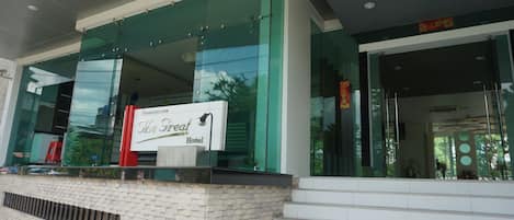 A hotel entrance with a sign reading "The Great Hotel."