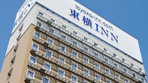 A multi-story building with a prominent sign for Toyoko Inn. - Toyoko Inn Shin Osaka Higashi Mikuni Station (Osaka)