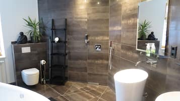 Separate tub and shower, rainfall showerhead, hair dryer, slippers