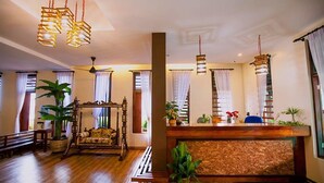 A spacious lobby with a reception desk, wooden flooring, and multiple hanging light fixtures. - House Of My Eternal Love - Kulai Homestay (Kulai)