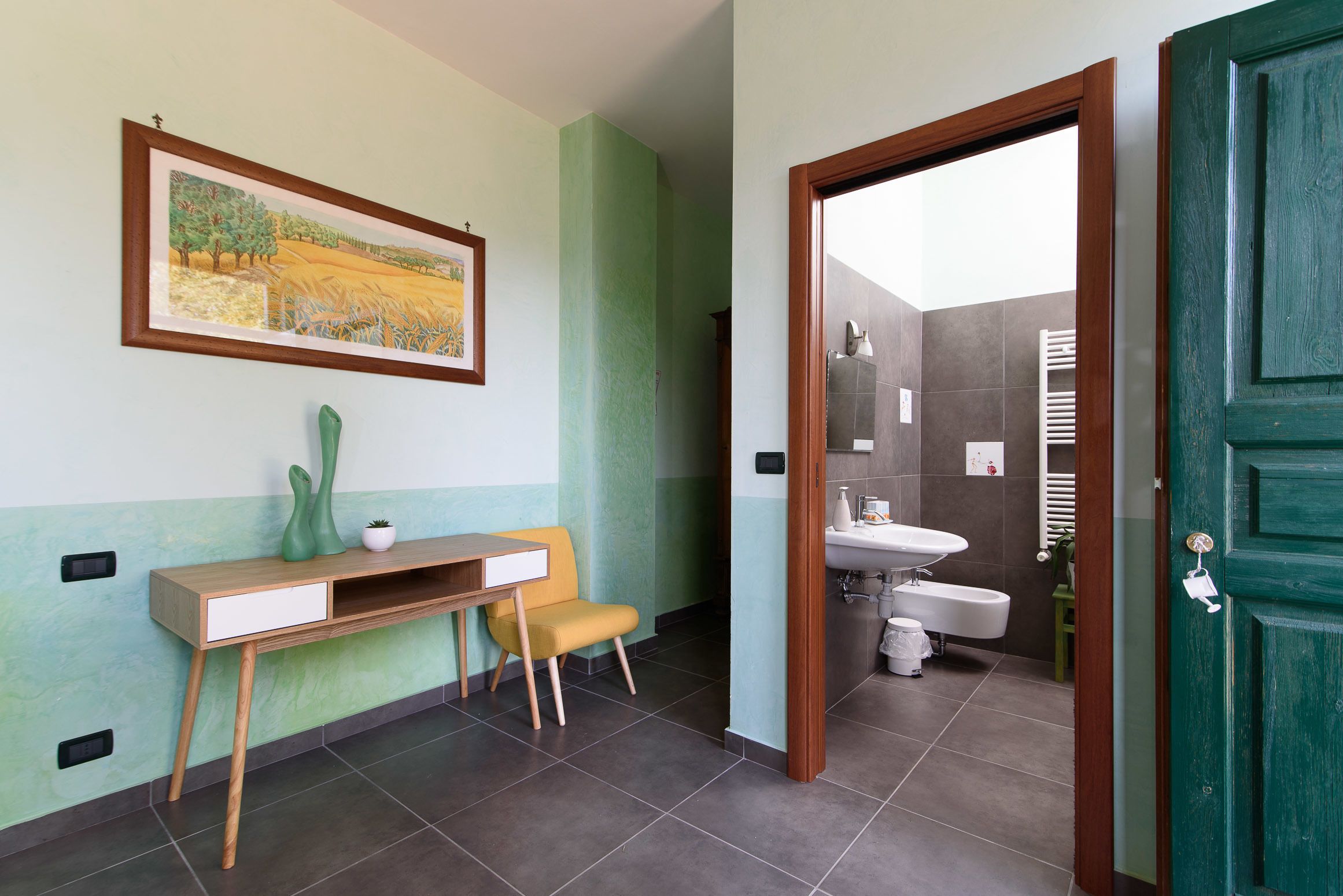 A bathroom with a sink, toilet, and shower area.