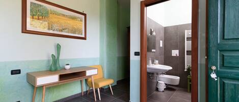 A bathroom with a sink, toilet, and shower area.