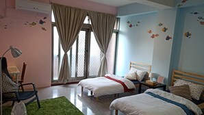 A bedroom with two beds, a desk, a chair, and a window with curtains. - Fish hostel (New Taipei City)