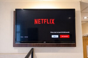 A television screen with the Netflix logo and pricing information. - The Kings Cross Hotel (Blackpool)