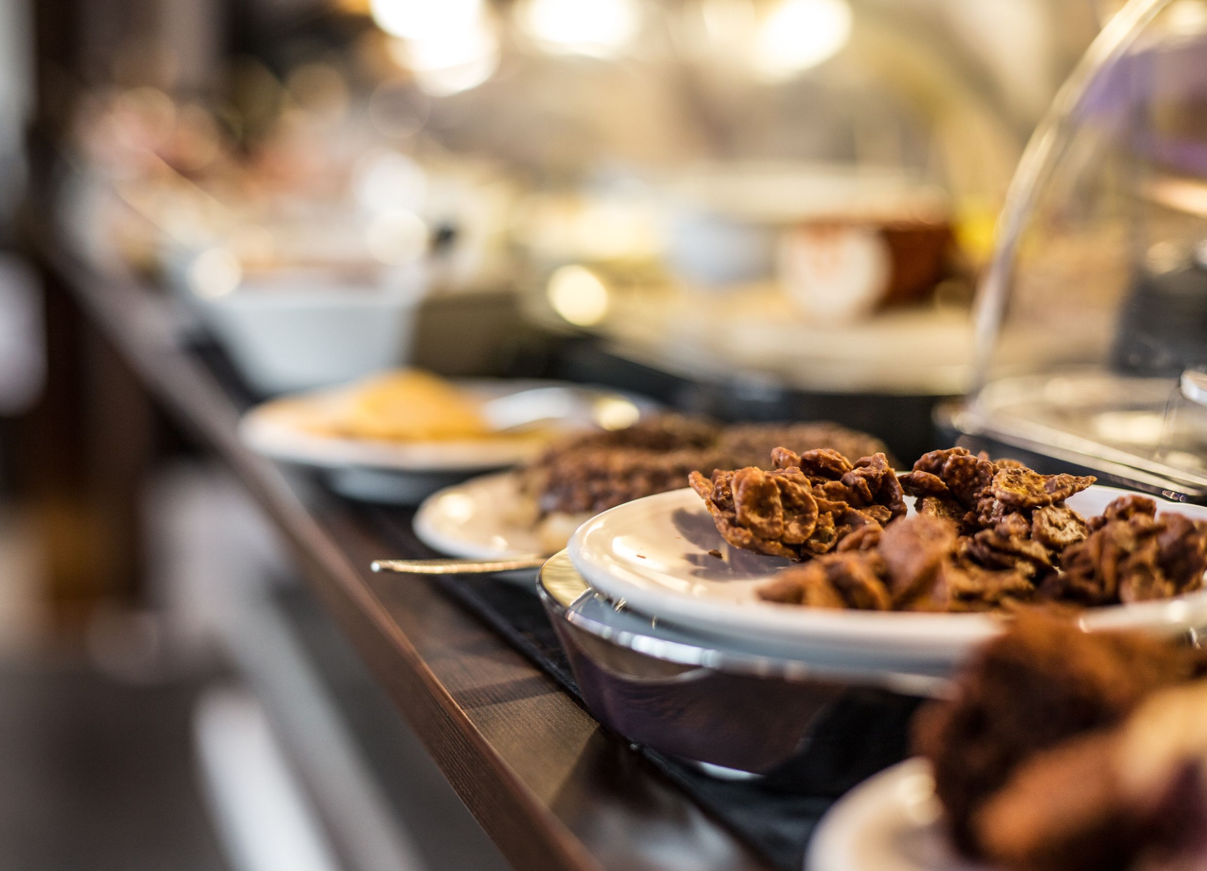 A buffet with various dishes, including fried items and a bowl of soup.