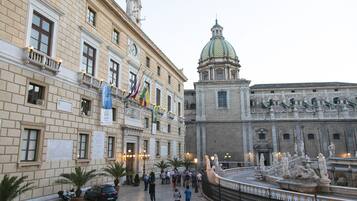 A historic building with classical architecture, a fountain, and a dome.