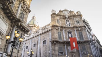 A historic building with ornate architecture, including a dome and statues.