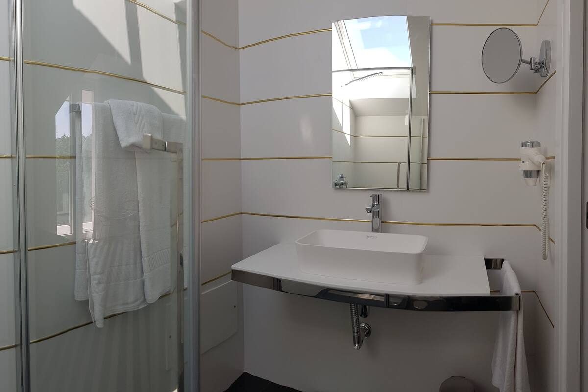 premium double or twin room | bathroom | free toiletries, hair dryer, slippers, towels