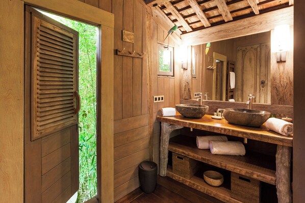 A wooden bathroom with a large window, wooden vanity, and a mirror. - Domaine Les Mésanges (Gassin)