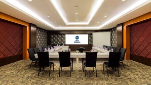 A conference room with a long table, black chairs, and a screen displaying "Best Western." - Best Western Senayan (Jakarta)