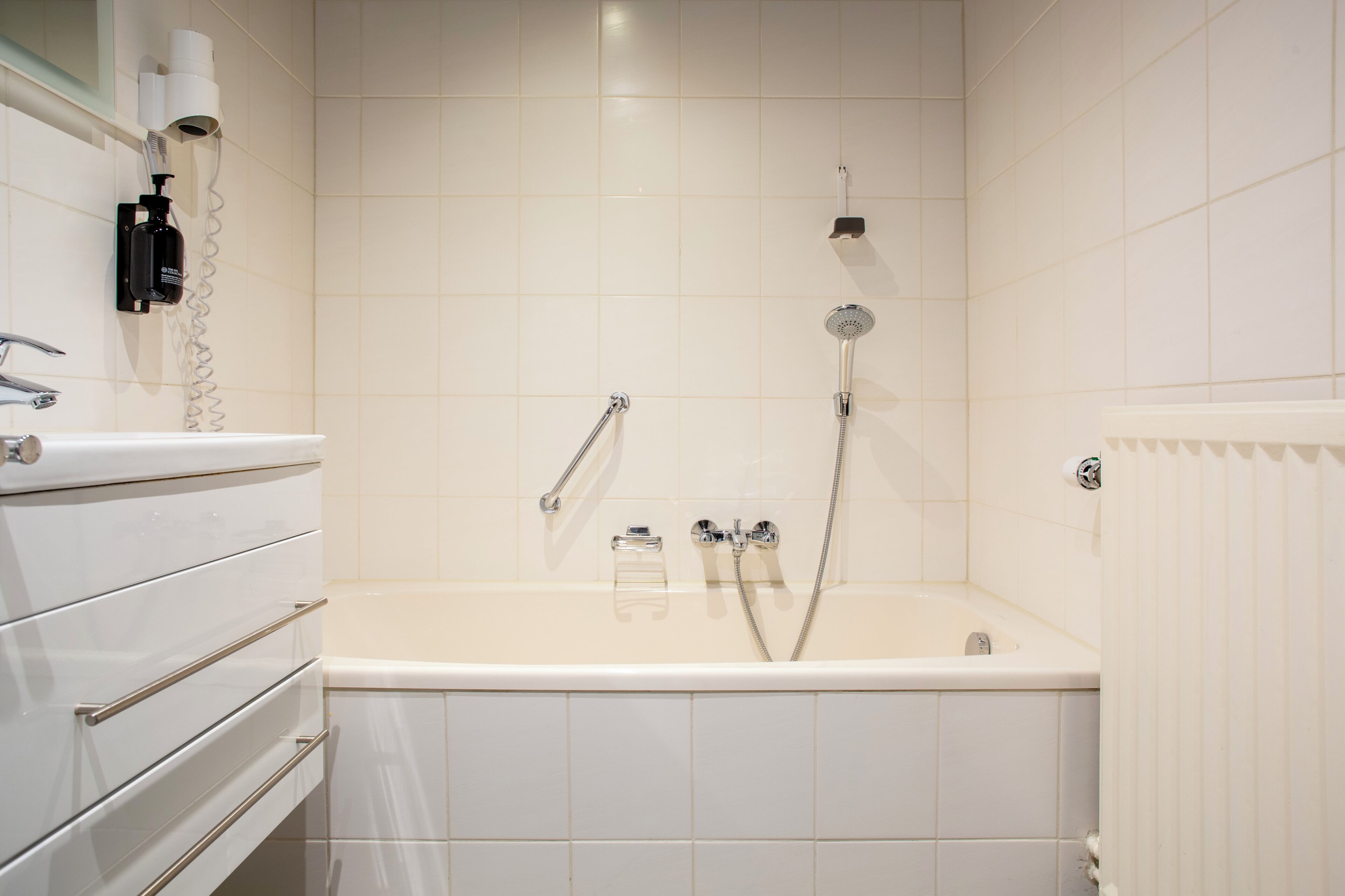 A bathroom with a bathtub, a toilet, a sink, and a shower.