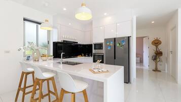 Villa 14 | Private kitchen | Full-size fridge, microwave, oven, stovetop