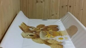 A small, enclosed space with a wooden wall and a white mattress or cushion on the floor. - Relais des Alpes (Giaglione)