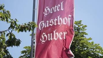 Una bandera con el texto "50 Jahre Hotel Gasthof Suber" y una corona de laurel.