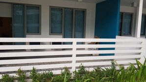 A white balcony with a blue wall and multiple windows. - 2 BR Condo by JAD at Azure Urban Resort Residences (Parañaque)