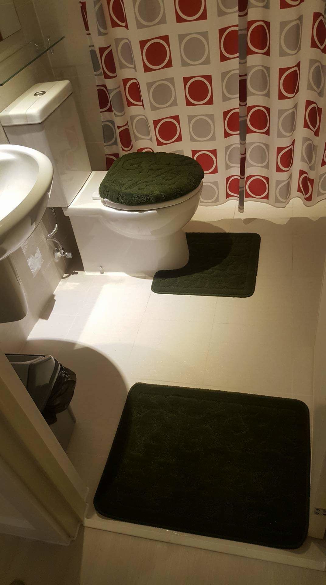 Ein Badezimmer mit Toilette, Waschbecken und Duschbereich.