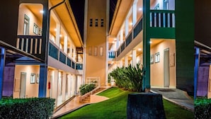A multi-story hotel with balconies, a central staircase, and a well-maintained lawn. - Engenho da Serra Hotel & Ecoresort (Capitólio)