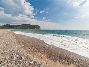 Beach nearby, white sand, beach umbrellas, beach towels