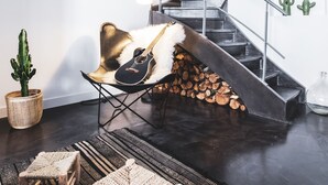 A modern interior with a staircase, a guitar, and rustic decor. - Antichambre (Nîmes)