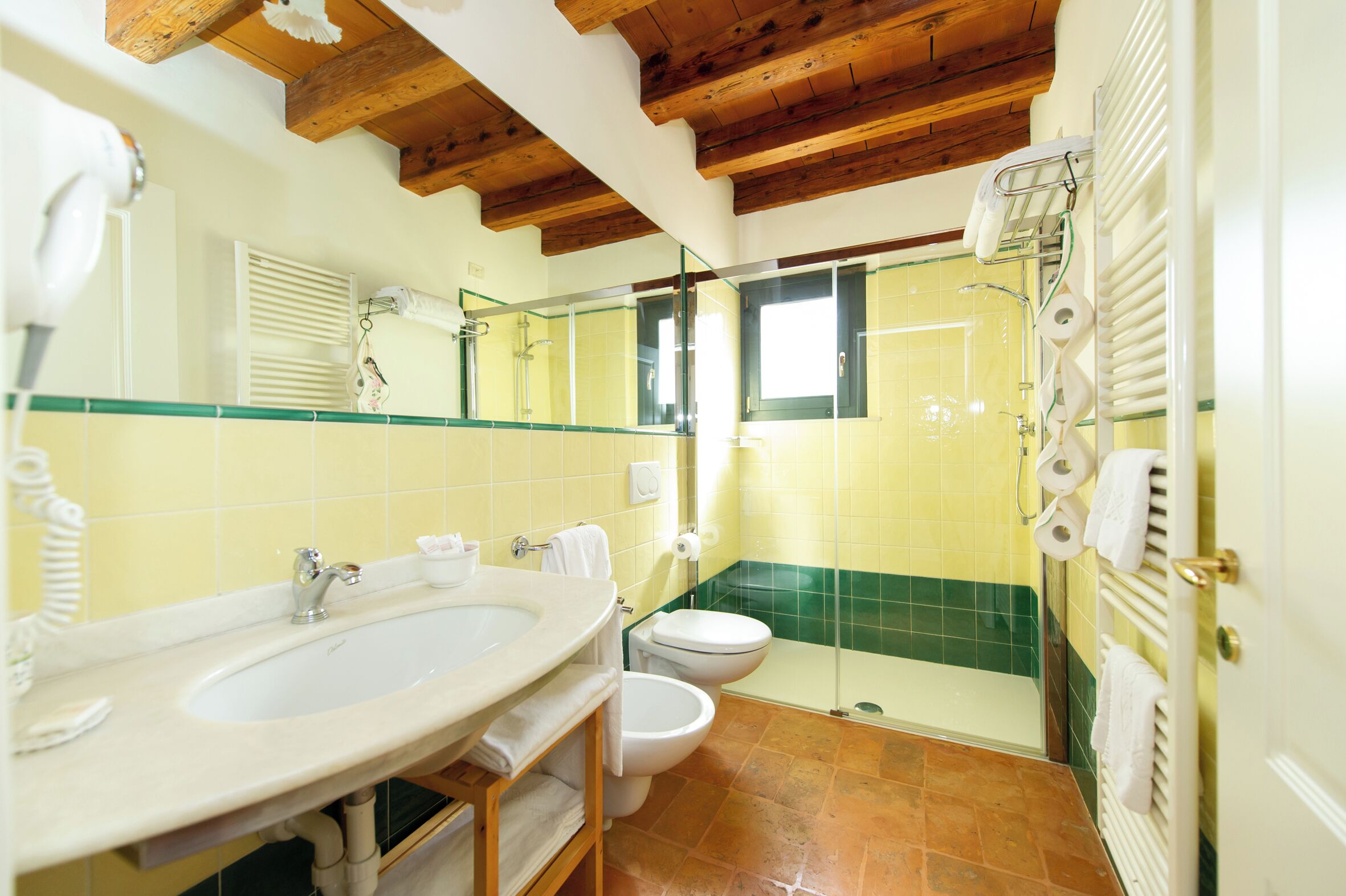 A bathroom with a sink, toilet, and shower.