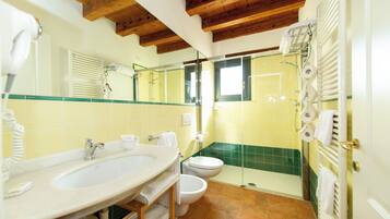 A bathroom with a sink, toilet, and shower.