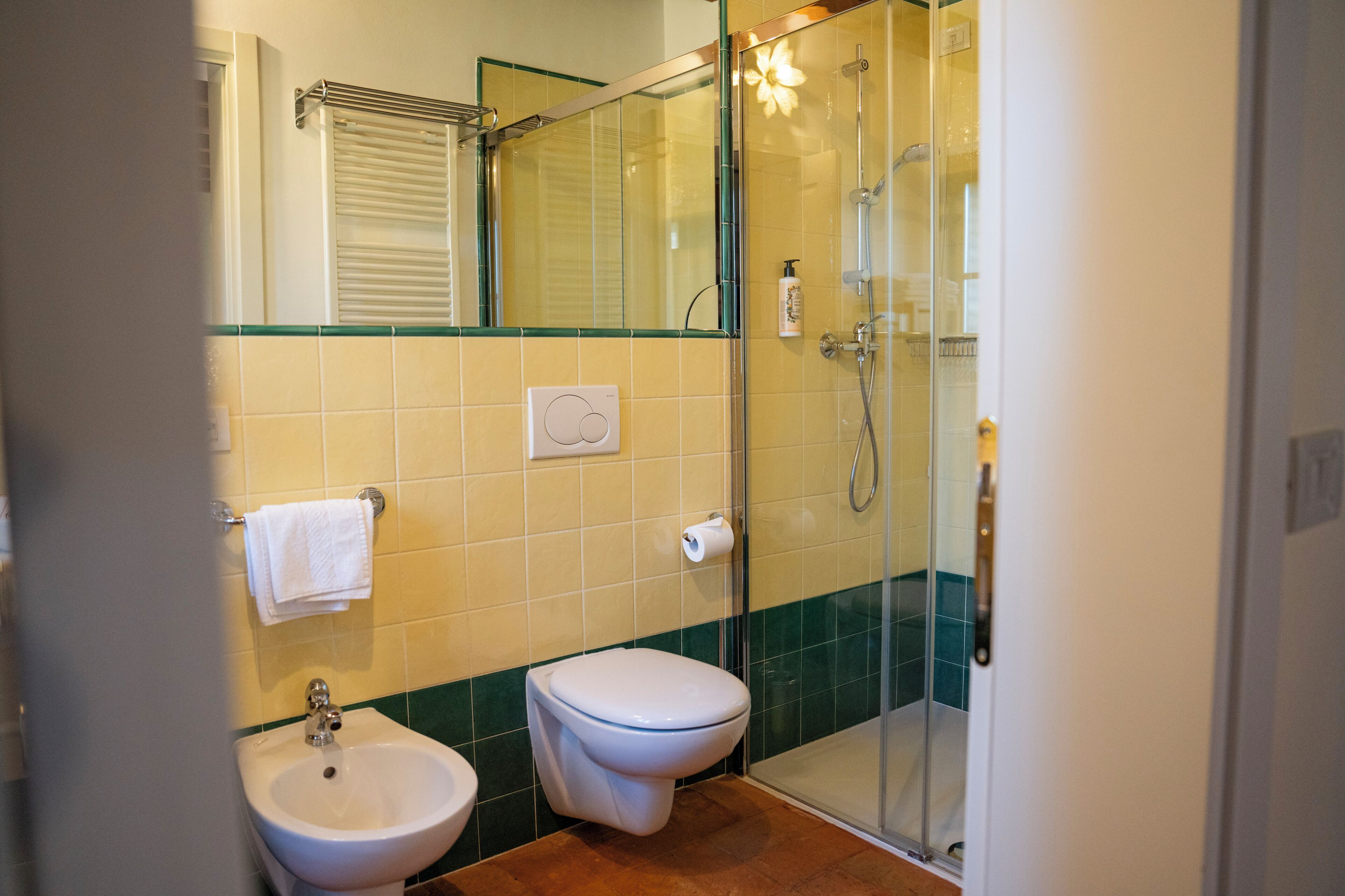 A bathroom with a toilet, sink, and shower.