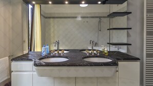 A bathroom with two sinks, a large mirror, and a shower. - Il Cielo di Lucio (Pisa)