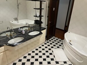 A bathroom with two sinks, a bathtub, and a tiled floor. - Il Cielo di Lucio (Pisa)