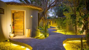 Stroll along the serene pathway to your retreat, surrounded by lush hedges and rustic charm.