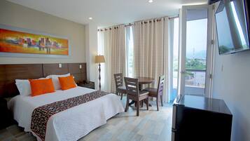 Deluxe Room, Balcony | Minibar, in-room safe, desk, free WiFi