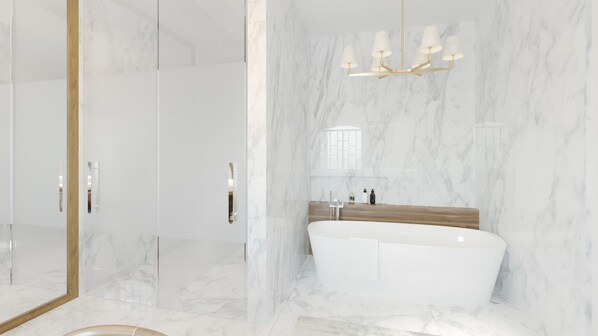 A modern bathroom with a freestanding bathtub, marble walls, and a large mirror with a gold frame.