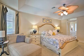 A bedroom with a bed, nightstands, a sofa, a ceiling fan, and a window with curtains. - < 1 Mi to Beach w/ Pool & Lanai: Marco Island Home (Marco Island)