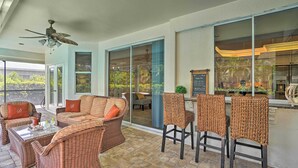 A covered patio area with wicker furniture, a ceiling fan, and a view of the outdoor space. - < 1 Mi to Beach w/ Pool & Lanai: Marco Island Home (Marco Island)