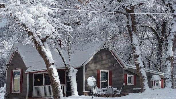 A two-story house with a snow-covered roof and a porch. - Charming Victorian Farmhouse, Privacy, Wi-FI , 5 min to Durango (Durango)