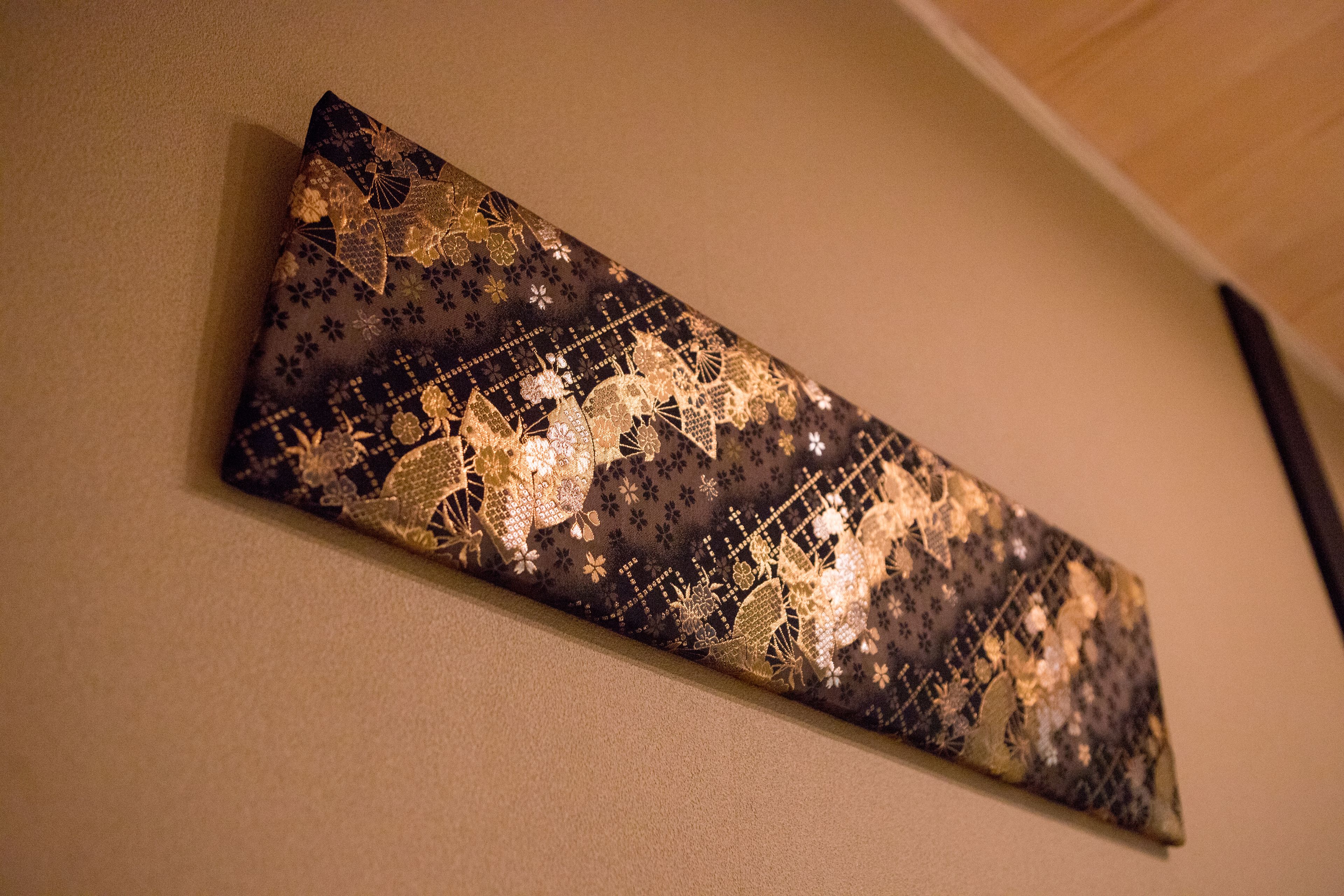 A wall with a decorative panel featuring a geometric pattern.