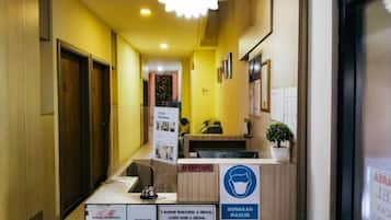 A reception area with a reception desk, a notice board, and a reception sign.