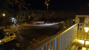 A nighttime view of a street with a parked car and a building in the background. - Apartment Santo Domingo, walled center  (Cartagena)
