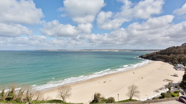 A beach with clear skies and calm waters.