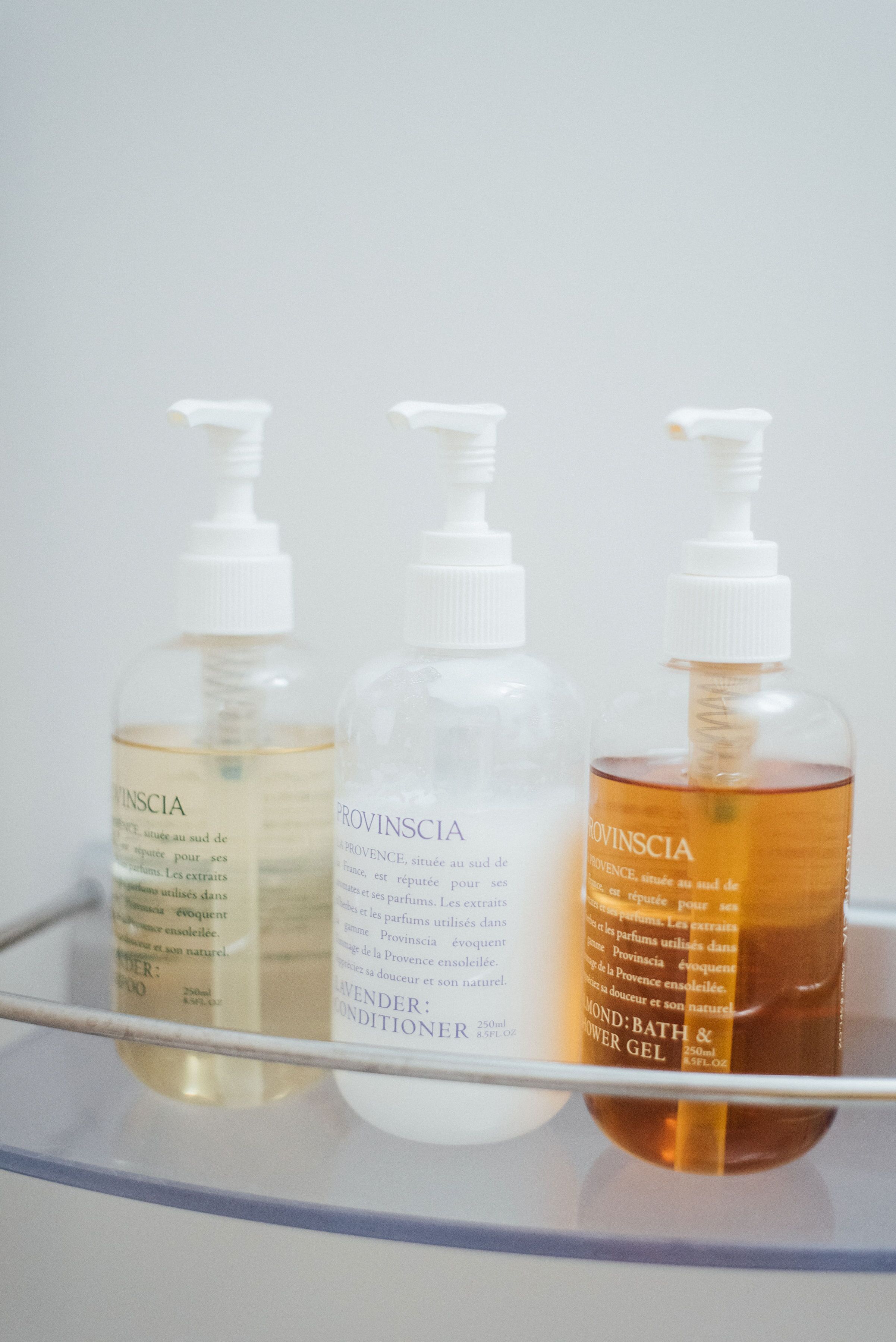 Three bottles of Provinscia bath and shower gel on a shelf.
